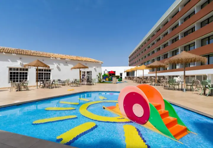 Piscina infantil con tobogán y juegos acuáticos en el hotel Carabela Matalascañas. ¡Diversión garantizada para los más pequeños!