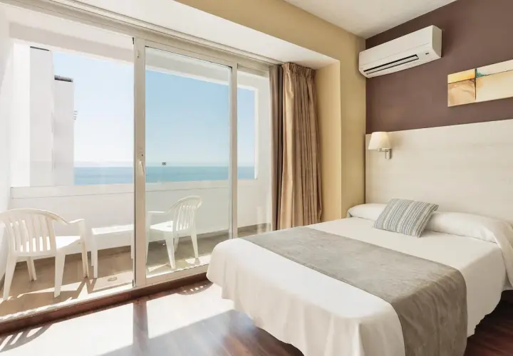 Habitación de hotel con cama, balcón con vistas al mar y aire acondicionado. Las **opiniones** del **hotel Best Indalo** destacan estas comodidades.